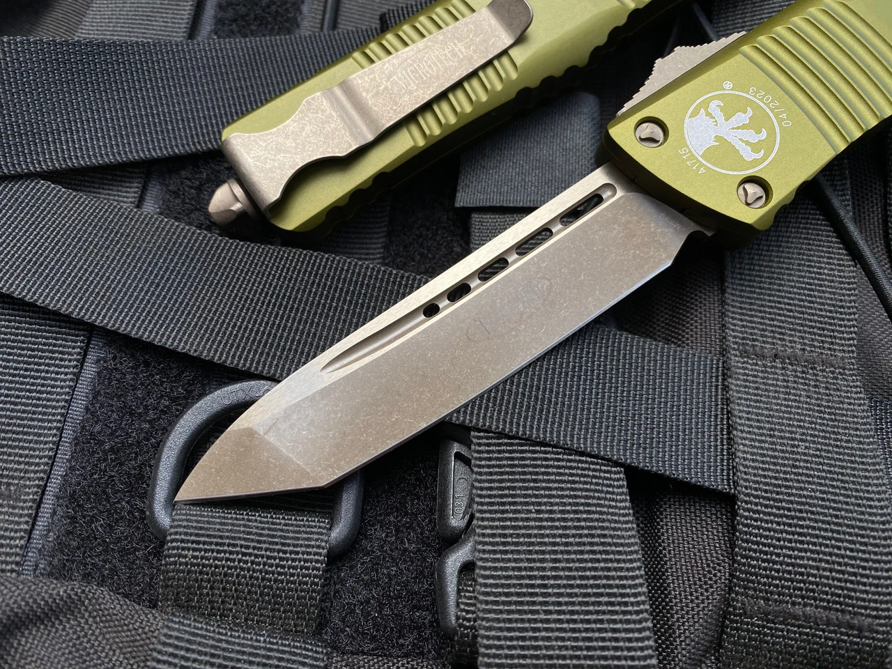 Microtech Combat Troodon T/E OD Green Aluminum Body W/ Bronzed Apocalyptic Hardware And Plain Edge Blade (3.8") 144-13APOD 4 Microtech Combat Troodon T/E OD Green Aluminum Body W/ Bronzed Apocalyptic Hardware And Plain Edge Blade (3.8") 144-13APOD - Image 4