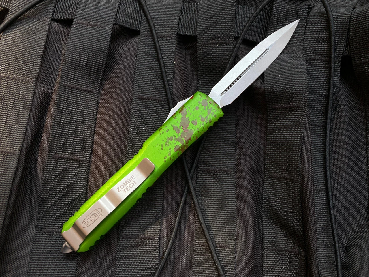 Microtech Zombietech D/E Green Aluminum Blood Splatter Body W/ Stonewashed Plain Edge Blade (3.4") 122-10Z 5 Microtech Zombietech D/E Green Aluminum Blood Splatter Body W/ Stonewashed Plain Edge Blade (3.4") 122-10Z - Image 5